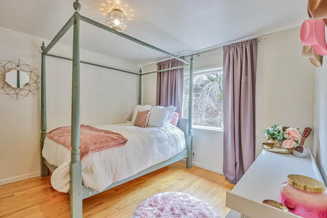 a bedroom with a bed and a window