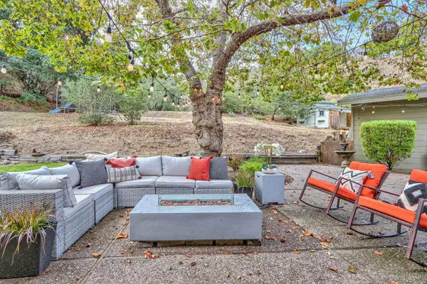 a backyard of a house with table and chairs