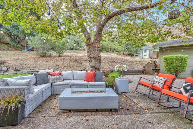 a backyard of a house with table and chairs