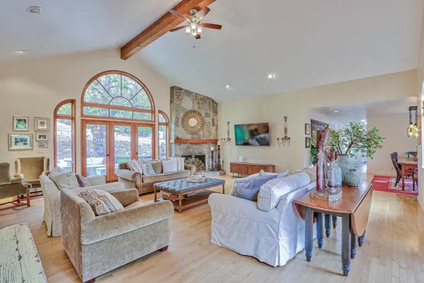 a living room with furniture a large window and a clock