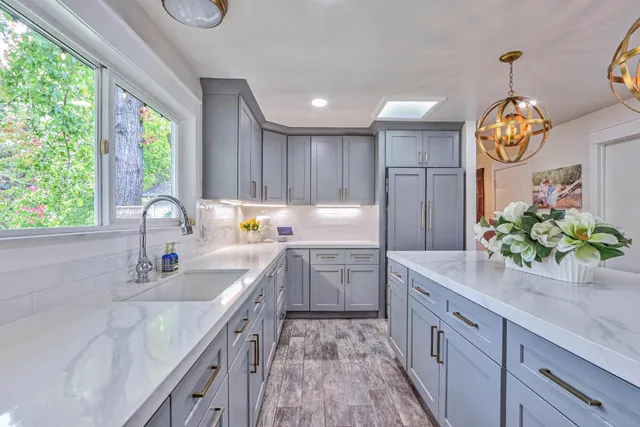 a kitchen with a sink stove and cabinets