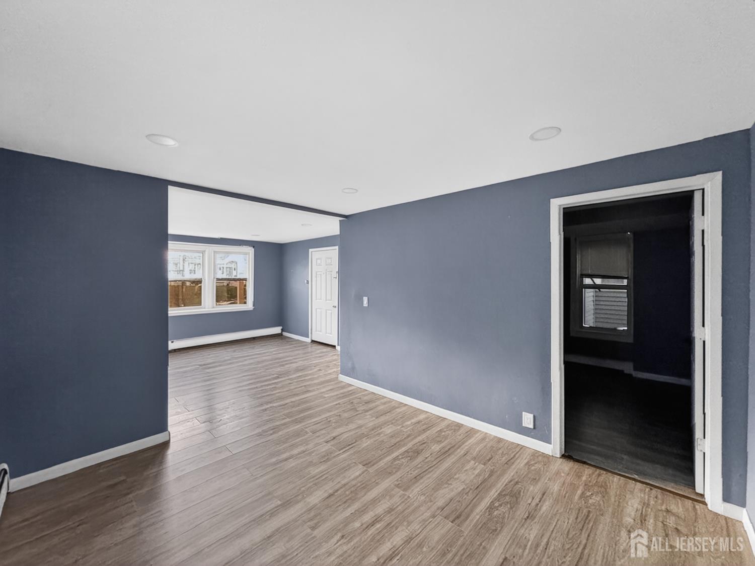 194 High Street, Unit 1 Perth Amboy, NJ 08861 - Photo 4 of 7 wooden floor in an empty room with a window