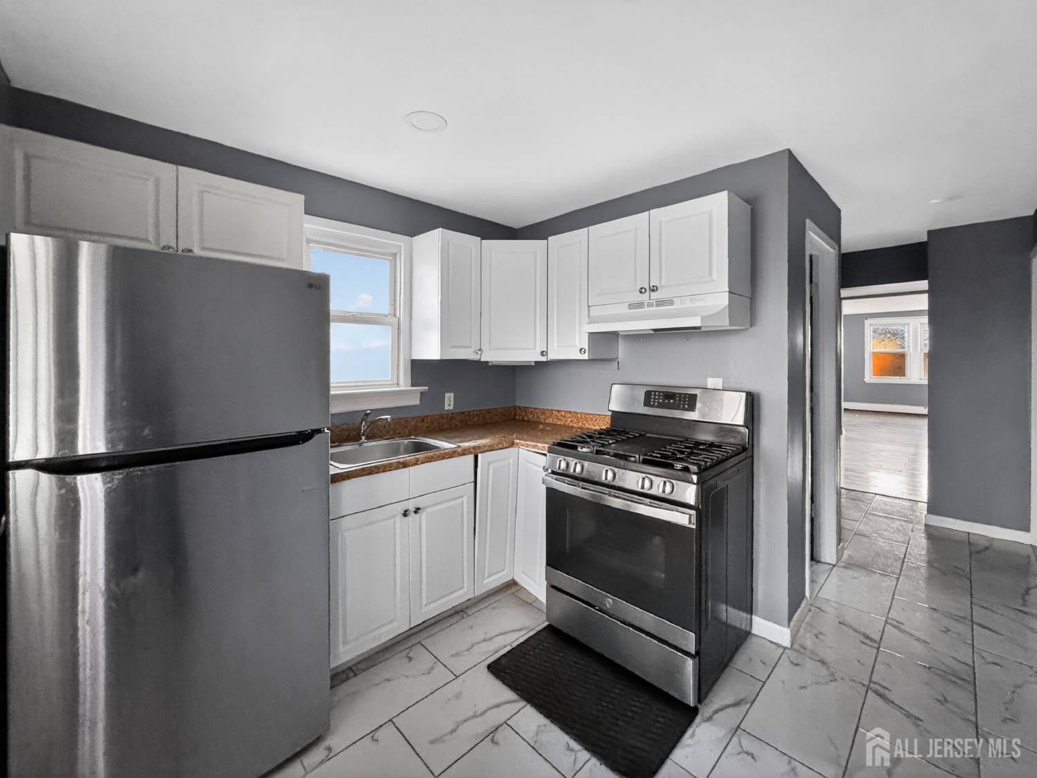 194 High Street, Unit 1 Perth Amboy, NJ 08861 - Photo 7 of 7 a kitchen with stainless steel appliances granite countertop a refrigerator sink and stove