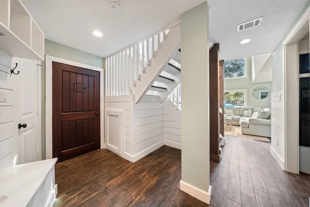 a view of a hallway view with wooden floor and staircase