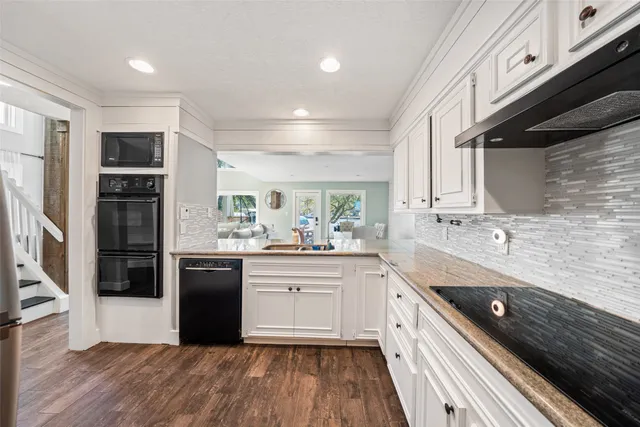 a bedroom with a large bed and a flat tv screen on dresser
