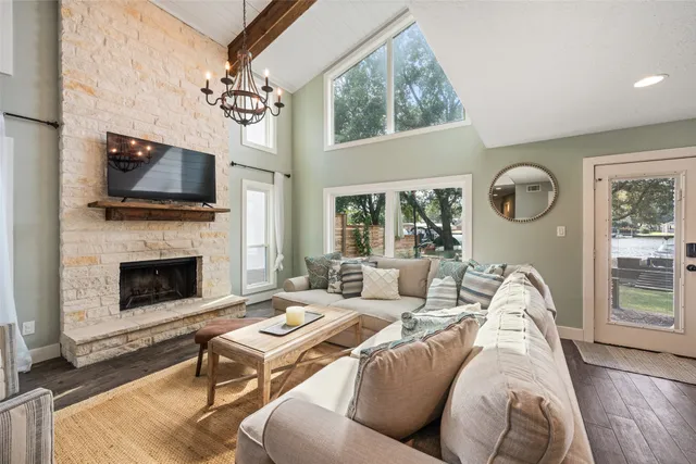 a living room with furniture a flat screen tv and a fireplace