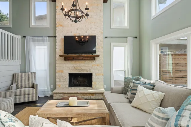 a living room with furniture fireplace and window