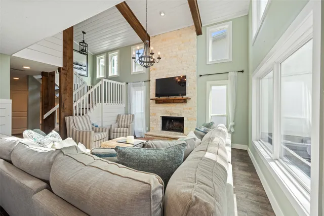 a living room with furniture a fireplace and a flat screen tv