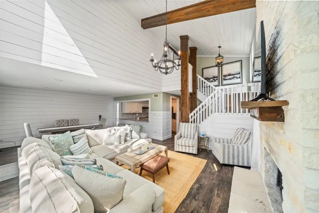 a living room with furniture or couch and a chandelier