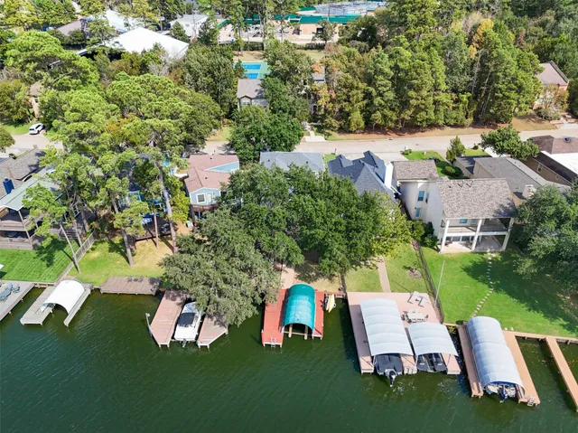 an aerial view of a house with outdoor space patio and trees all around