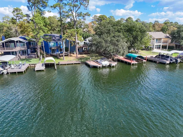 a view of a lake with a house swimming pool and outdoor space