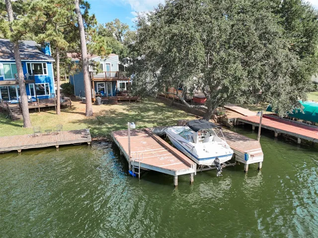 an aerial view of a house with swimming pool having outdoor seating