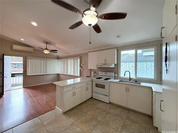 a kitchen with granite countertop a stove sink and cabinets