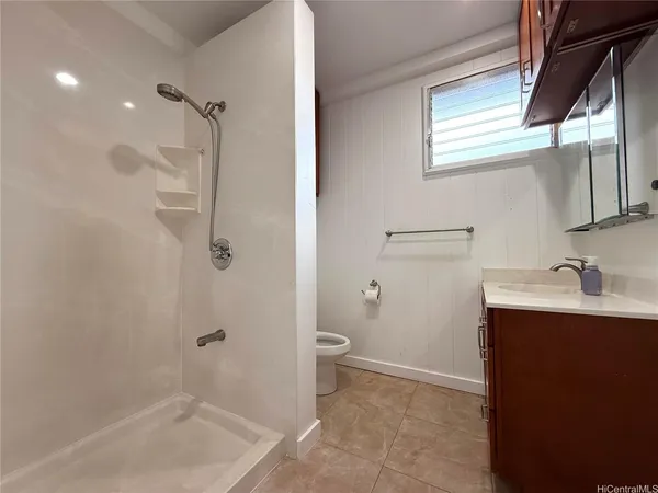a bathroom with a granite countertop sink toilet and shower