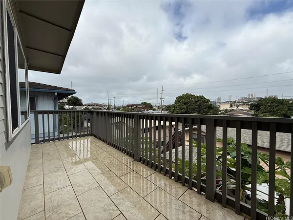 a balcony with trees in front of it
