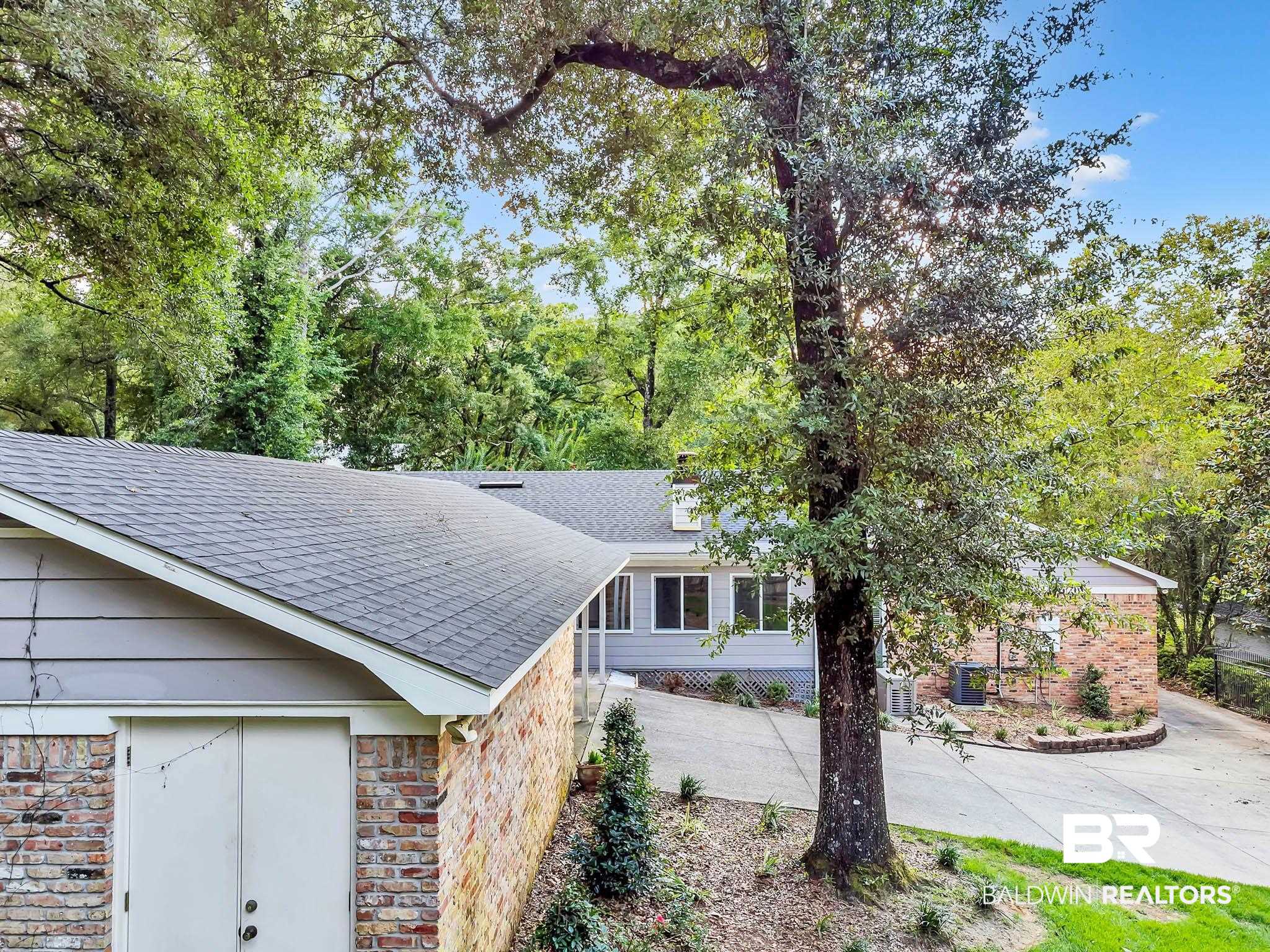 309 West Brandy Run Road Mobile, AL 36608 - Photo 98 of 100 Exterior view of a shingled roof and brick siding