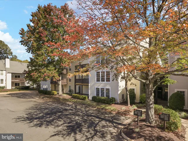 a view of a large building with a tree in front