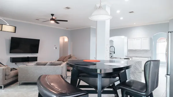 a view of a dining room with furniture and a flat screen tv
