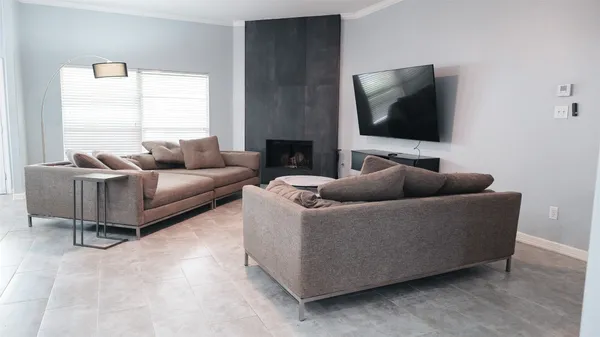 a living room with couches and a flat screen tv