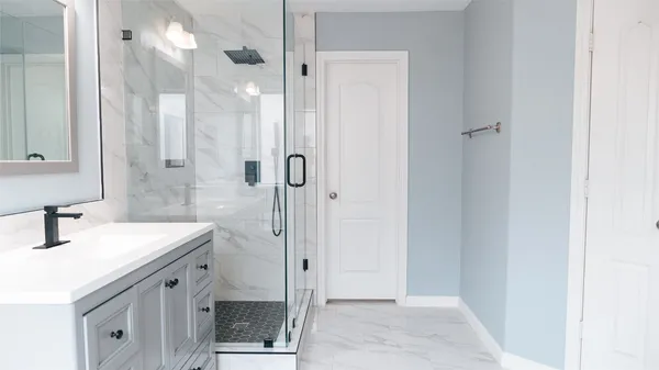 a bathroom with a sink a mirror and a shower