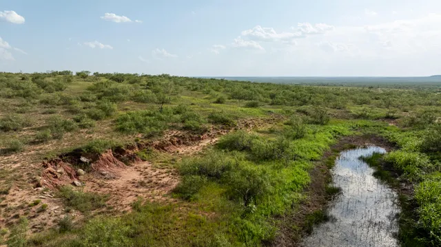 a view of an empty room with a lake view