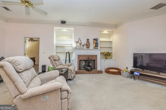 a living room with furniture and a fireplace