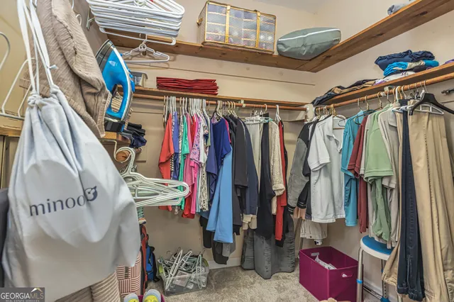 a view of walk in closet with clothes