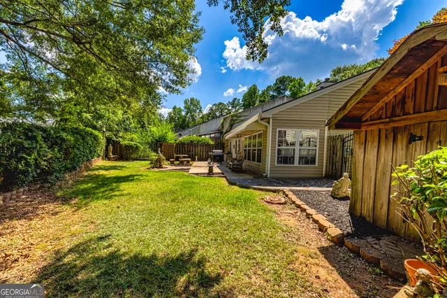 a view of house with backyard and garden