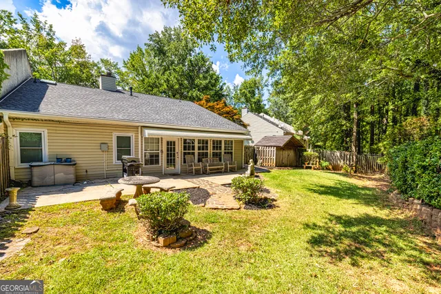 a front view of a house with a garden and patio