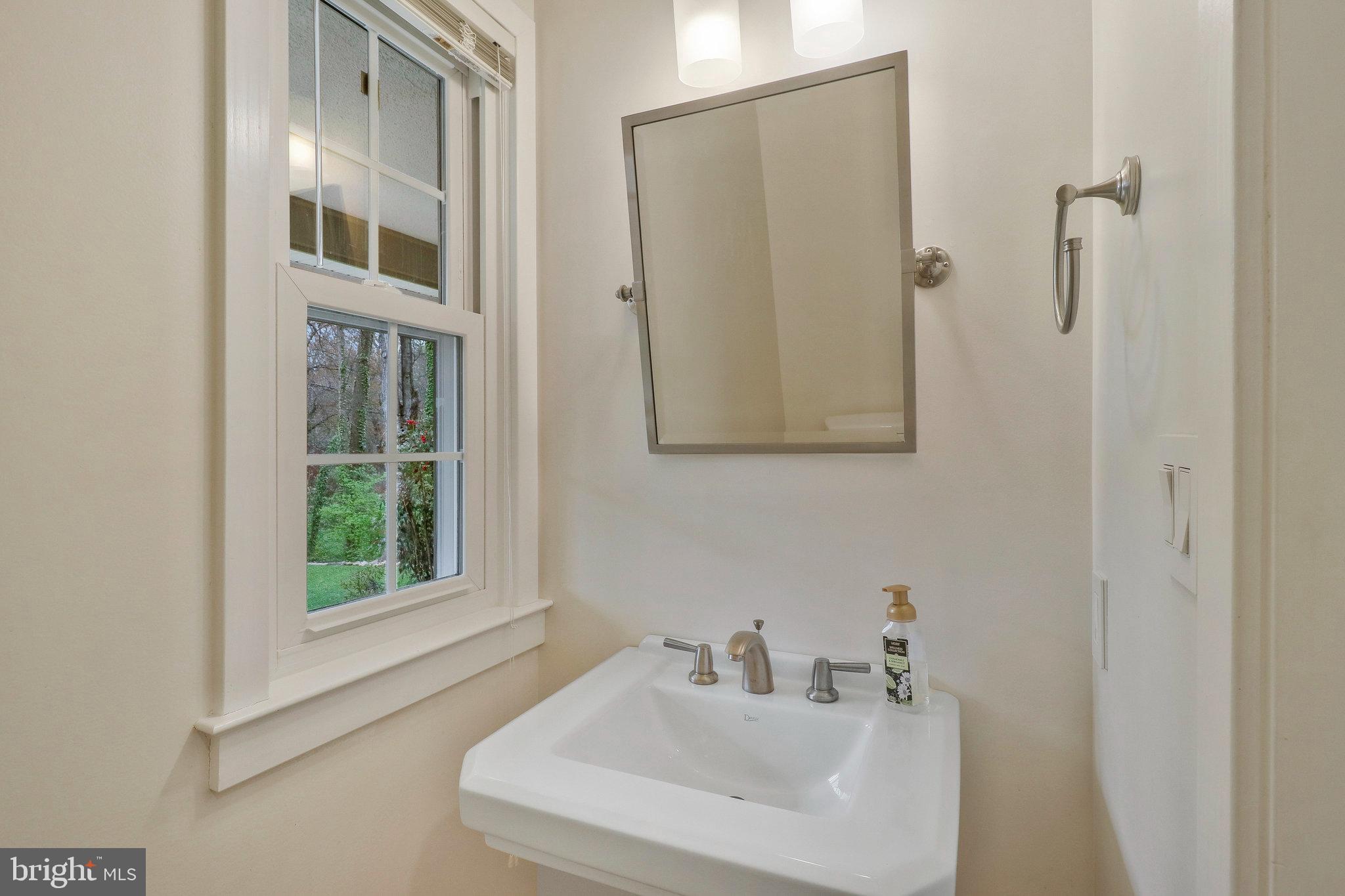 8543 Howell Road Bethesda, MD 20817 - Photo 13 of 24 a bathroom with a sink and a mirror