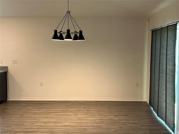 a view of a room with wooden floor and a window