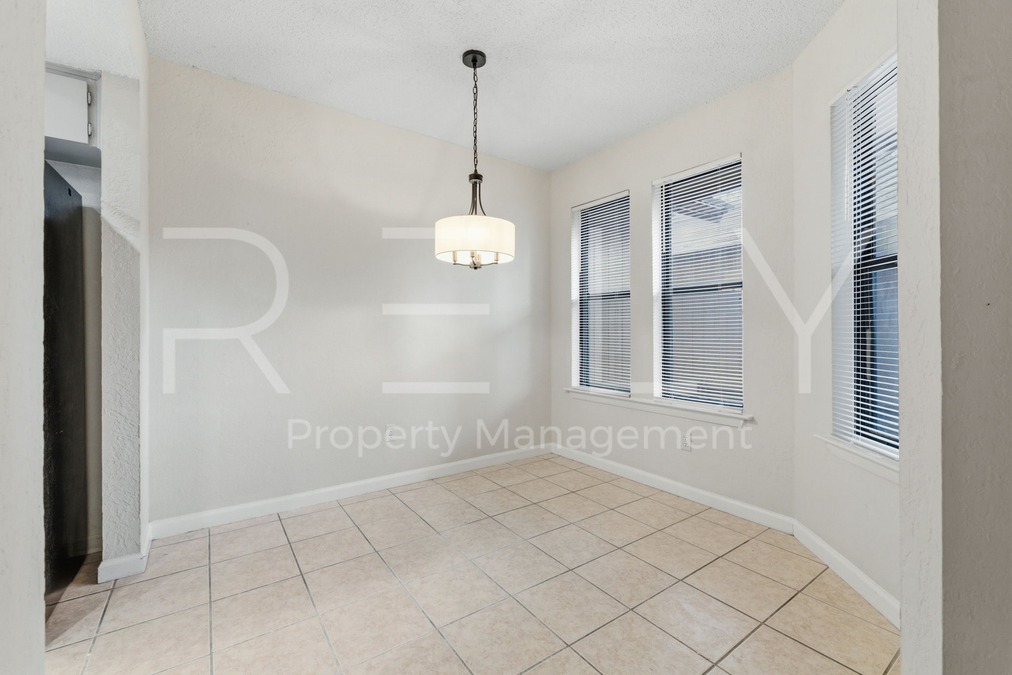 1005 Milford Way, Unit A Austin, TX 78745 - Photo 11 of 30 a view of an empty room with window and chandelier