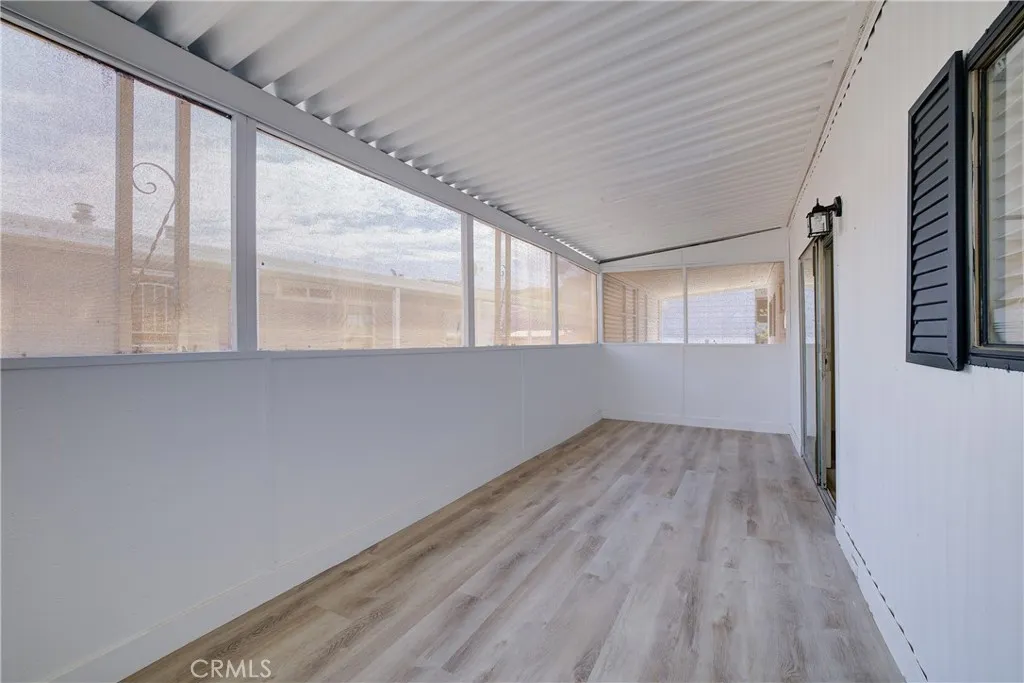 3700 Buchanan Street, Unit 164 Riverside, CA 92503 - Photo 34 of 40 an empty room with wooden floor and windows