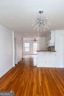 1875 Brewer Boulevard Southwest Atlanta, GA 30310 - Photo 2 of 15 a view of an empty room with window and wooden floor