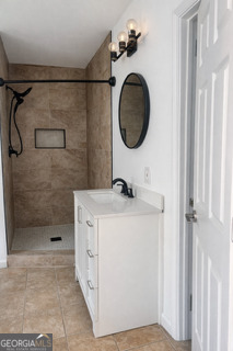 1875 Brewer Boulevard Southwest Atlanta, GA 30310 - Photo 3 of 15 a bathroom with a sink a vanity and a mirror