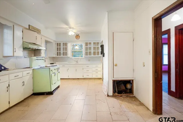 a kitchen with a sink cabinets and window