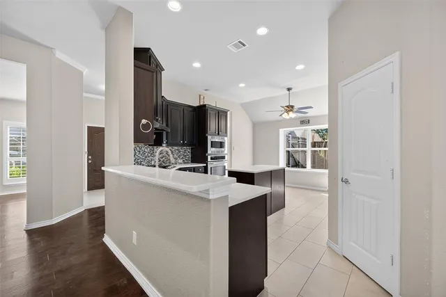 a kitchen with stainless steel appliances a sink stove and refrigerator