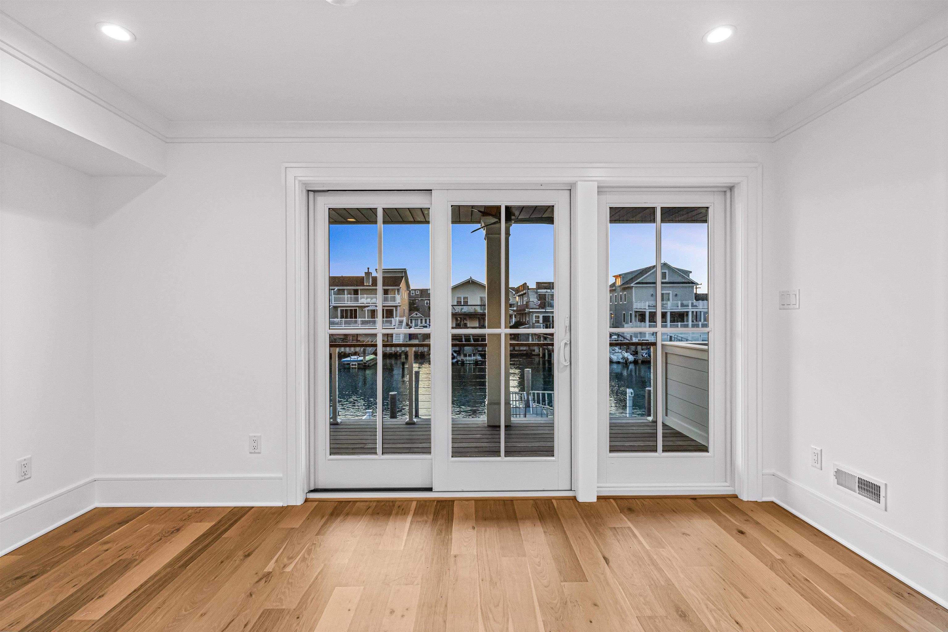2148 Ocean, Unit 2148 Avalon, NJ 08202 - Photo 12 of 40 an empty room with wooden floor and windows