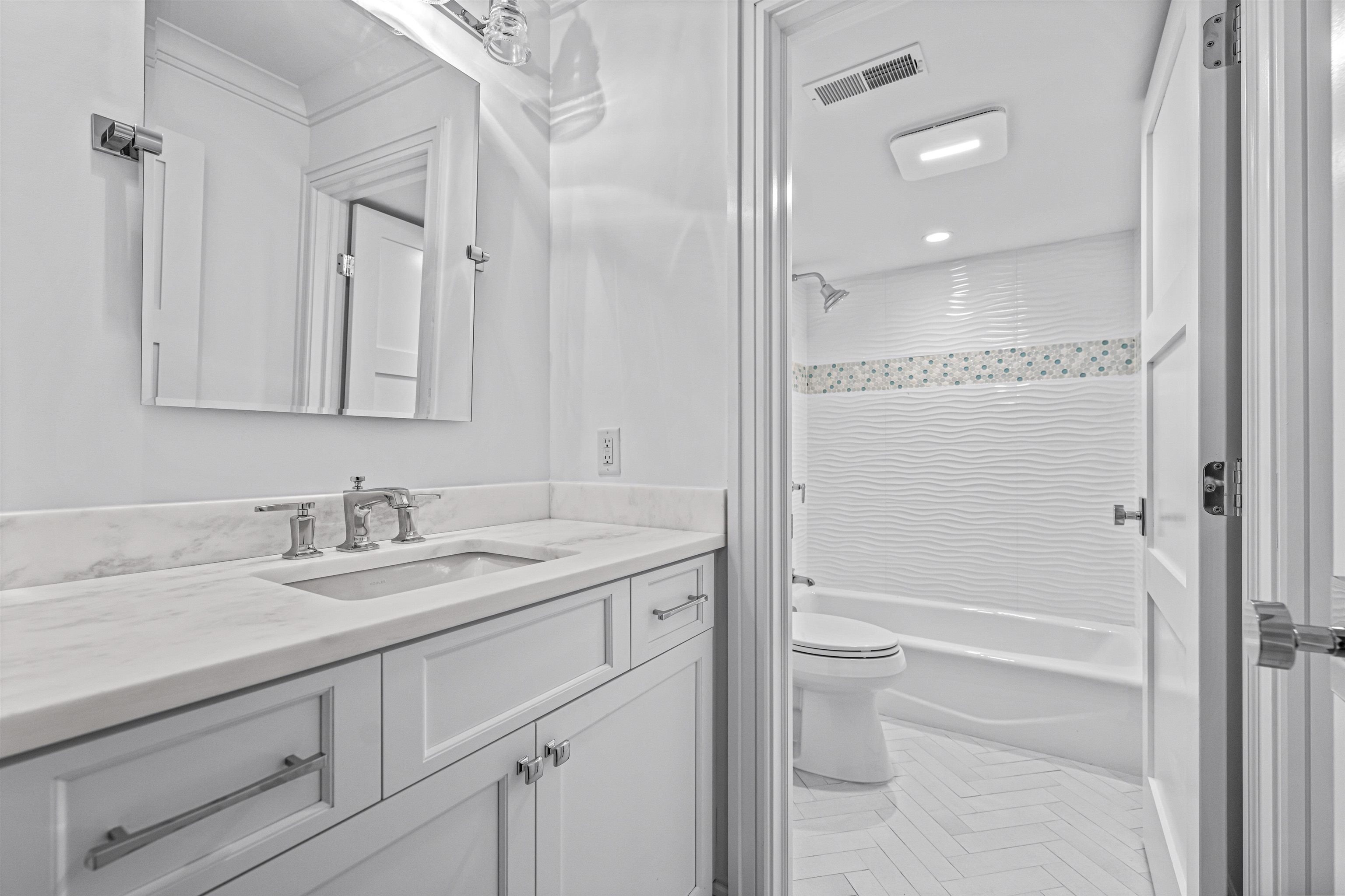 2148 Ocean, Unit 2148 Avalon, NJ 08202 - Photo 13 of 40 a bathroom with a granite countertop sink toilet and shower