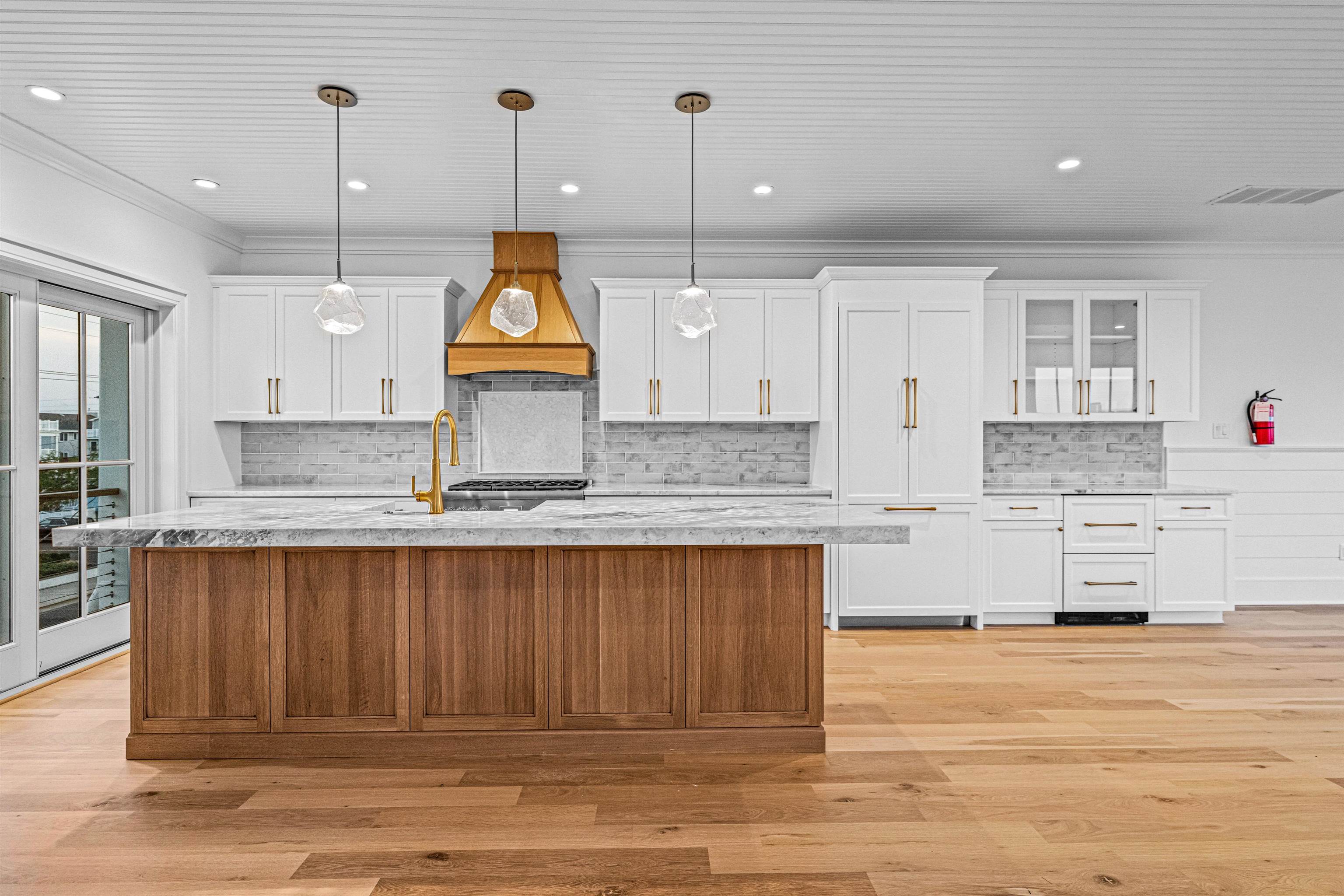 2148 Ocean, Unit 2148 Avalon, NJ 08202 - Photo 16 of 40 a kitchen with kitchen island granite countertop a stove a sink and a wooden floors