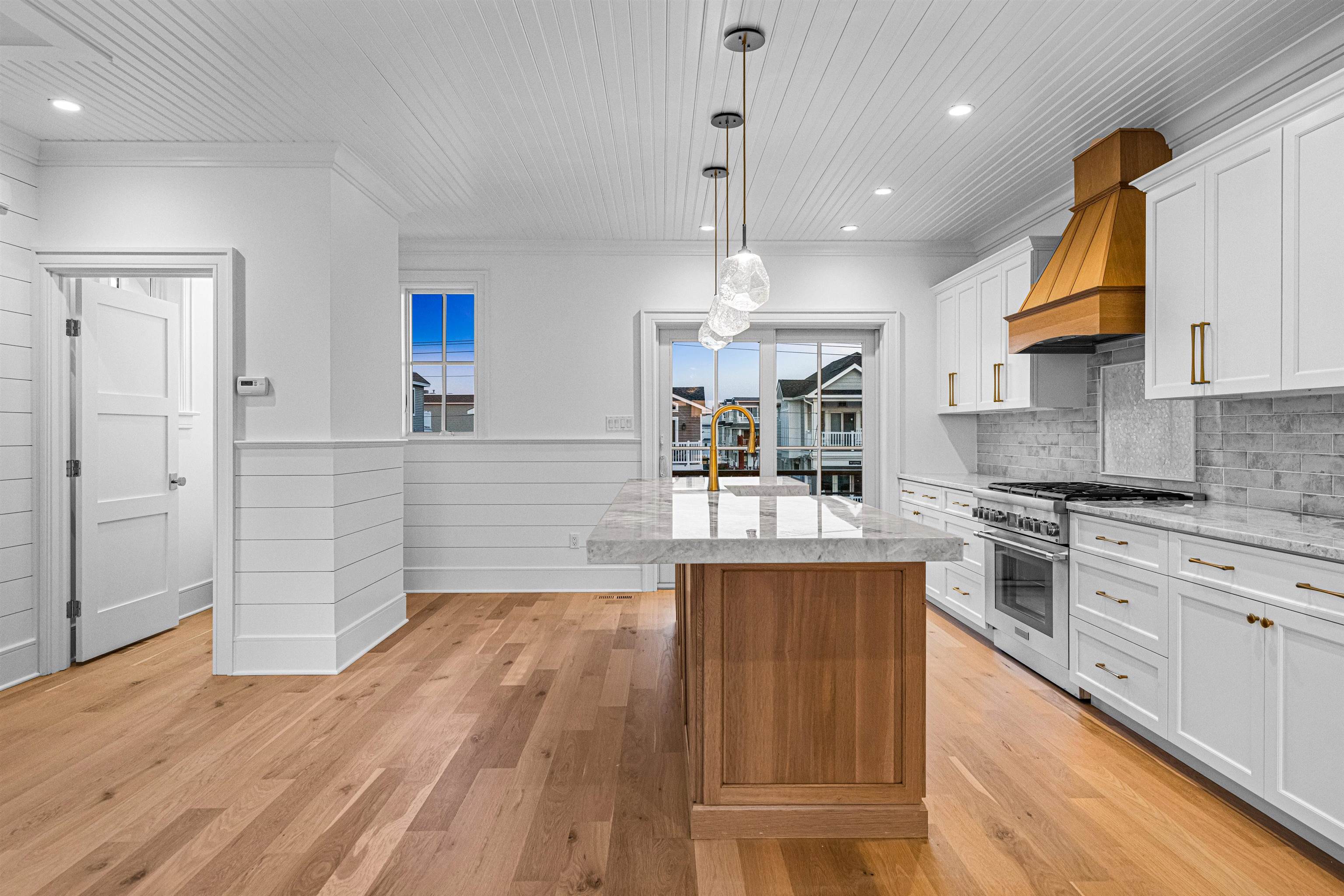 2148 Ocean, Unit 2148 Avalon, NJ 08202 - Photo 18 of 40 a kitchen with stainless steel appliances granite countertop wooden floors and view of living room