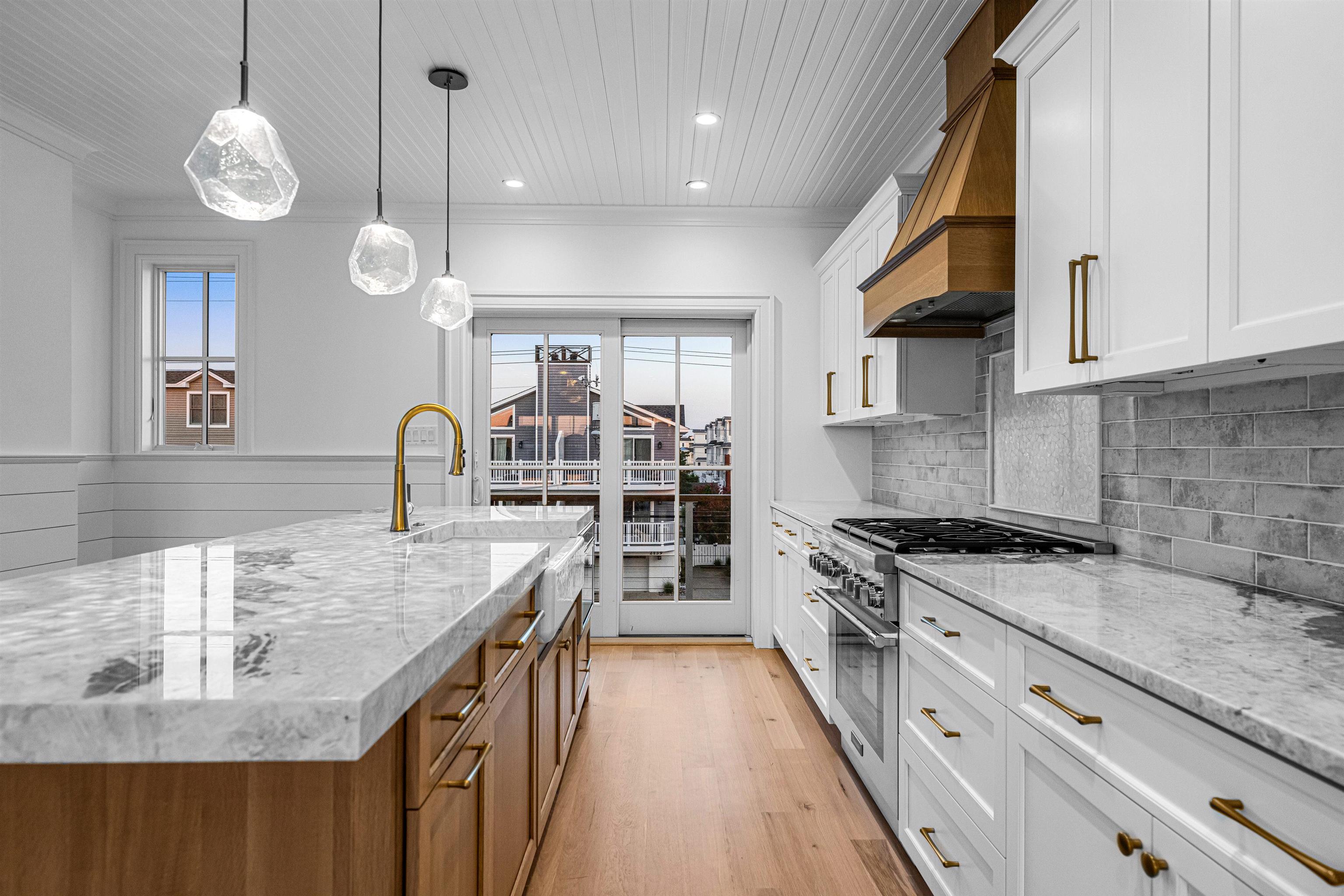 2148 Ocean, Unit 2148 Avalon, NJ 08202 - Photo 19 of 40 a kitchen with stainless steel appliances granite countertop a sink a stove and a wooden floors