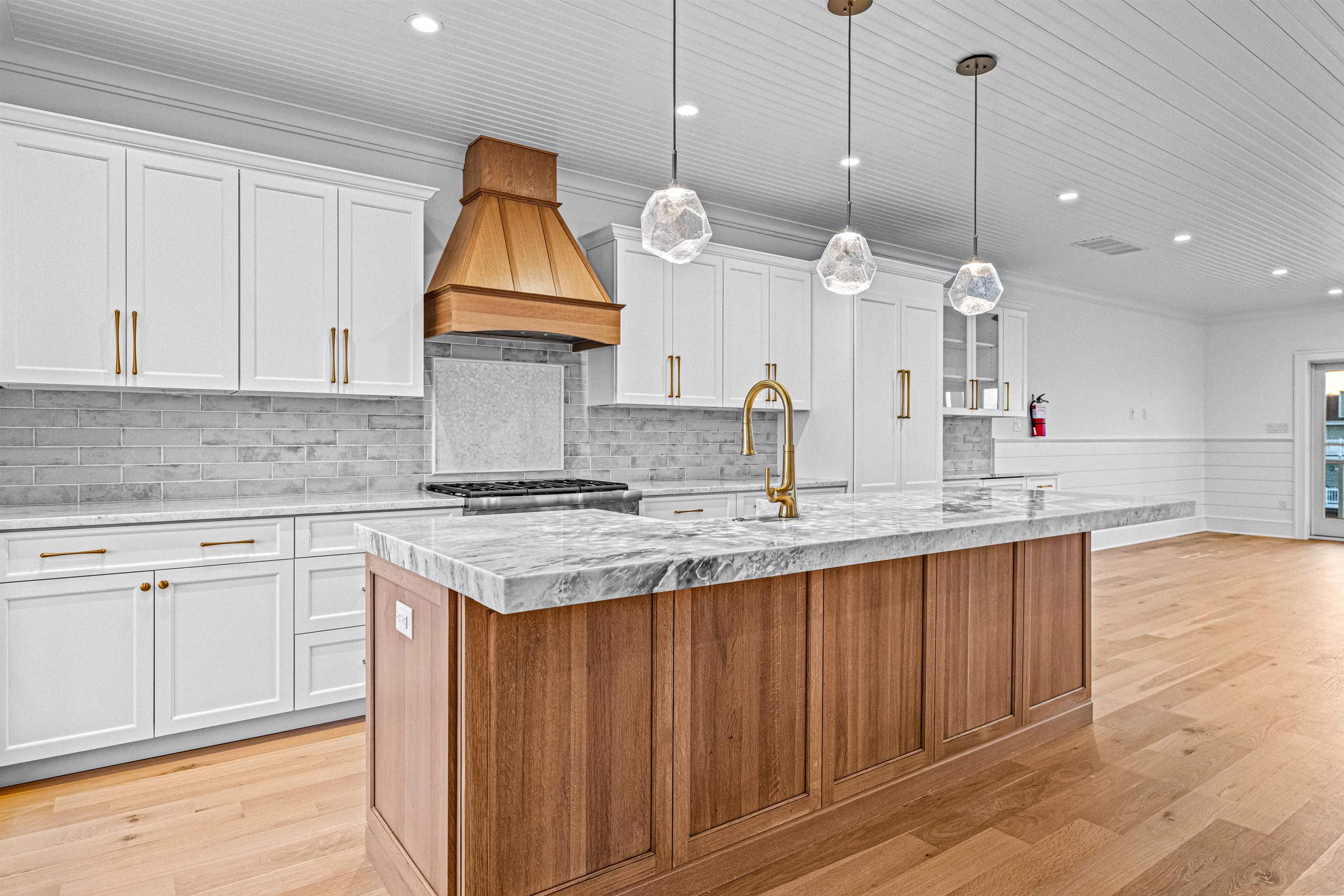2148 Ocean, Unit 2148 Avalon, NJ 08202 - Photo 22 of 40 a kitchen with granite countertop wooden cabinets and a large window