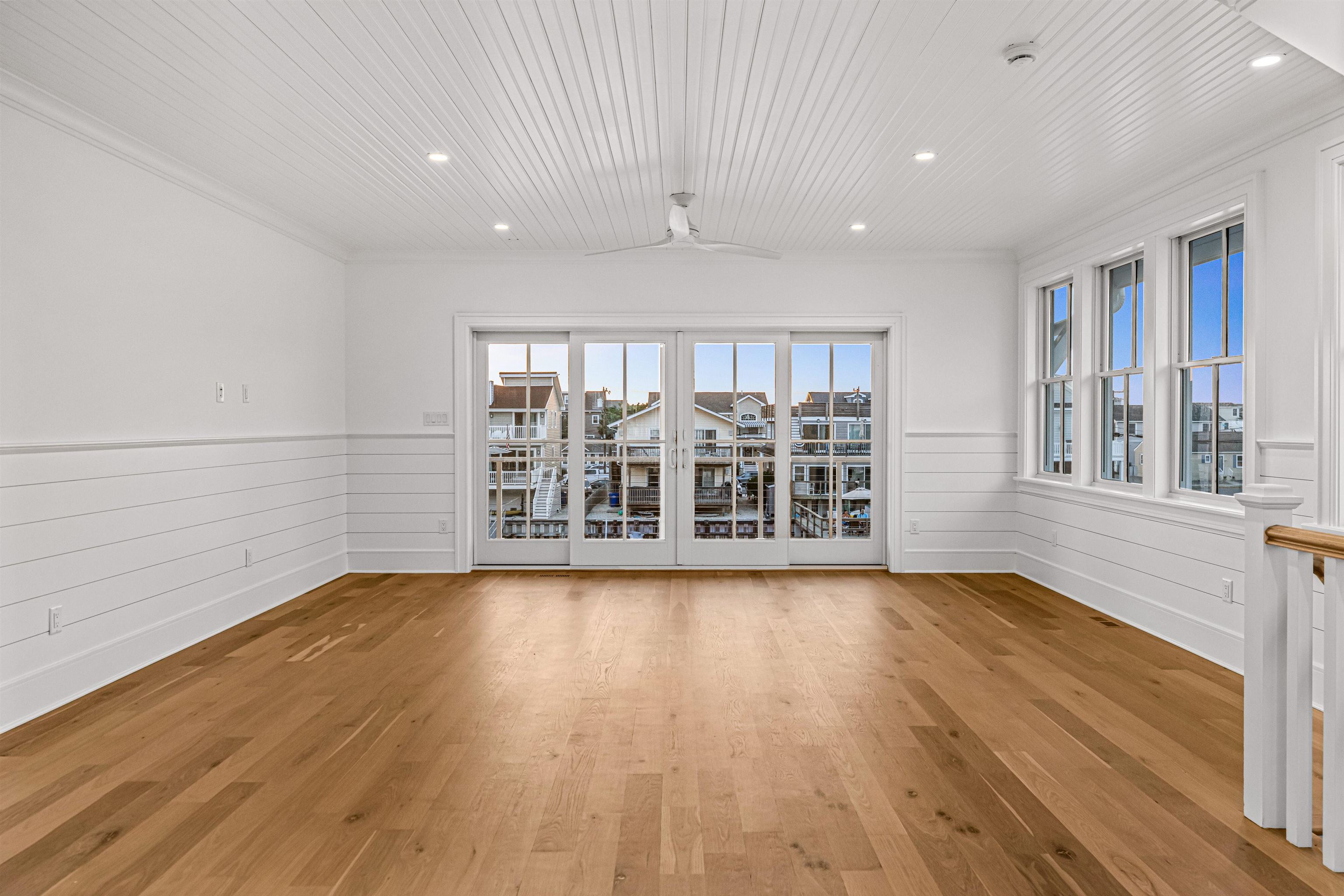 2148 Ocean, Unit 2148 Avalon, NJ 08202 - Photo 24 of 40 a view of an empty room with wooden floor and a window