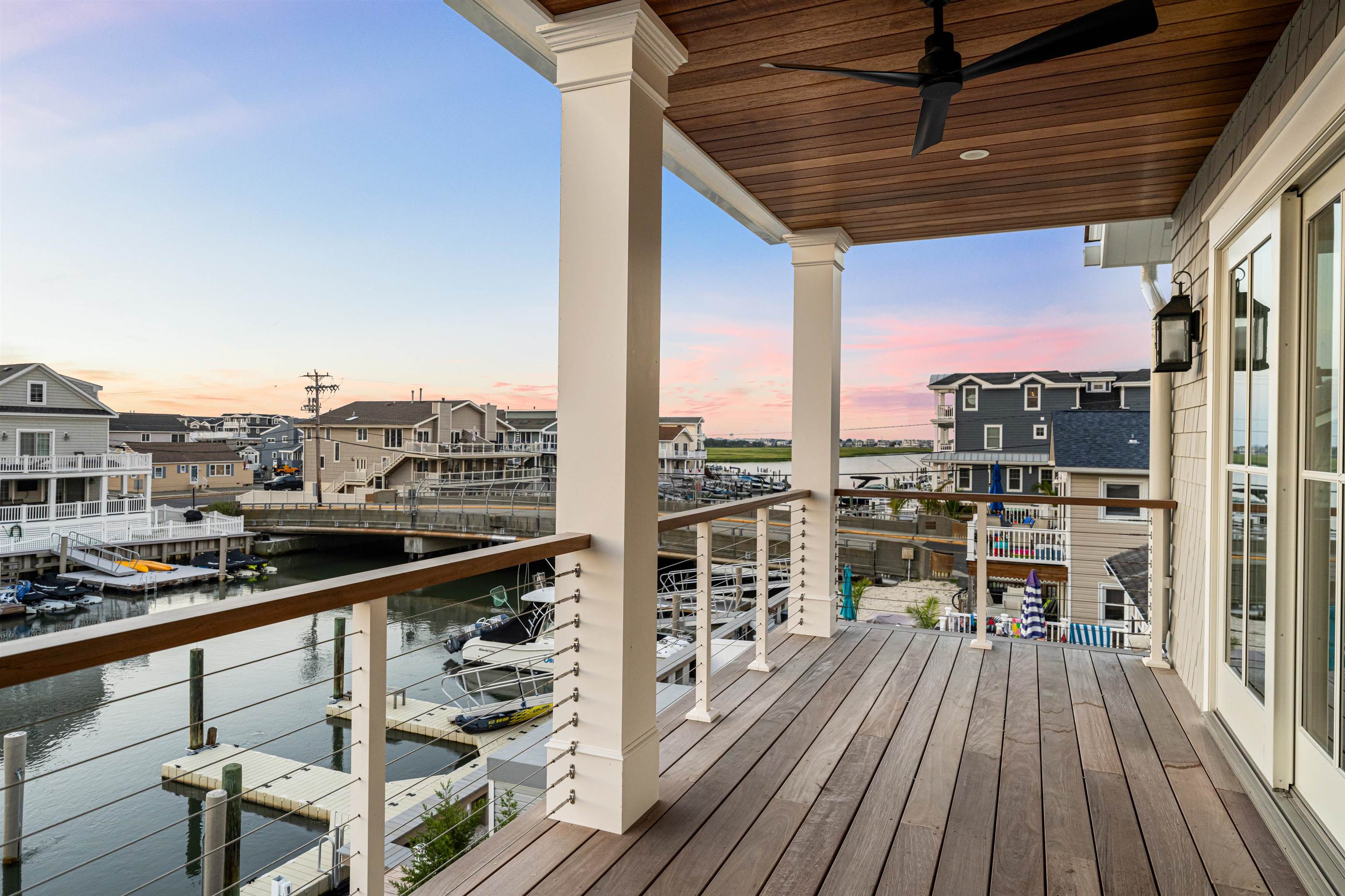 2148 Ocean, Unit 2148 Avalon, NJ 08202 - Photo 27 of 40 a view of a balcony with wooden floor and outdoor seating