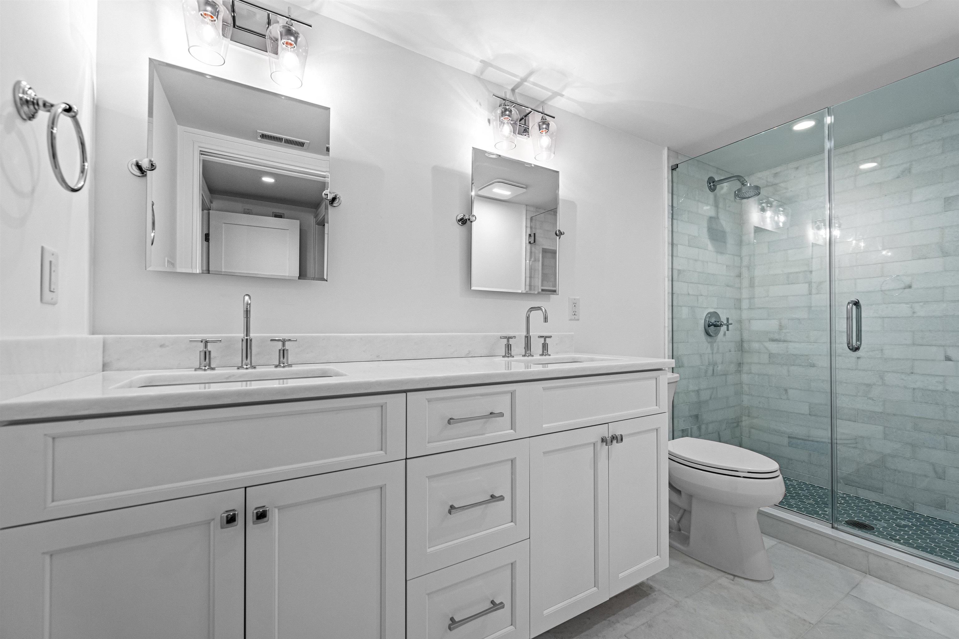 2148 Ocean, Unit 2148 Avalon, NJ 08202 - Photo 32 of 40 a bathroom with a double vanity sink mirror and toilet