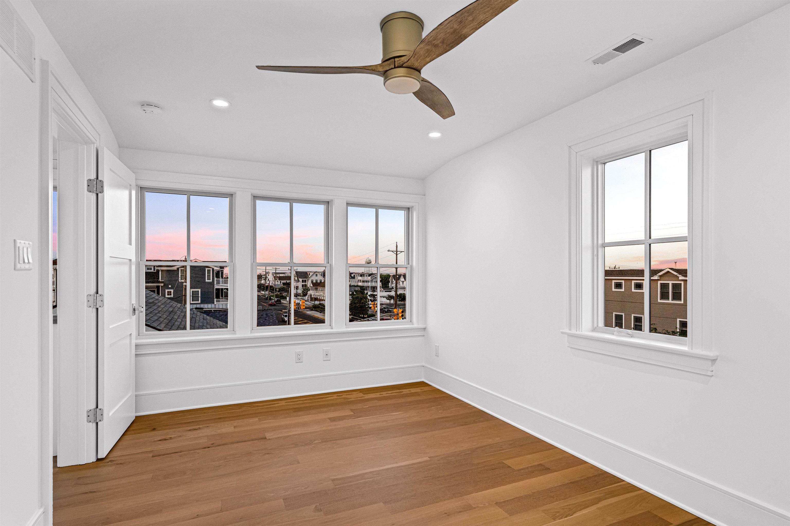 2148 Ocean, Unit 2148 Avalon, NJ 08202 - Photo 35 of 40 a view of an empty room with a window and wooden floor