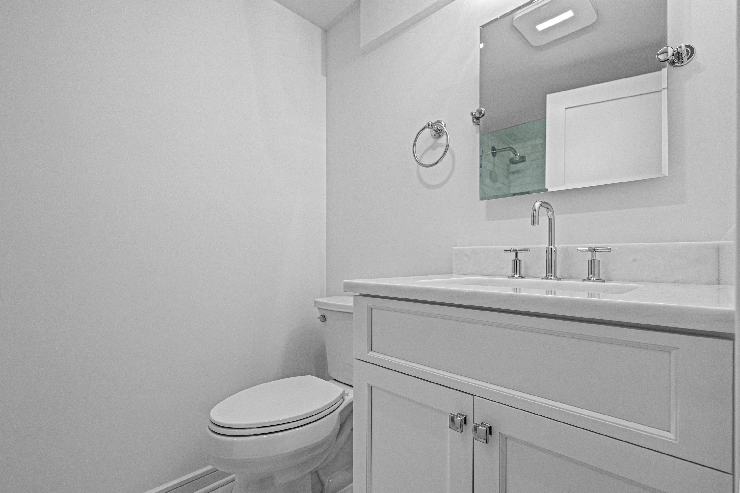 2148 Ocean, Unit 2148 Avalon, NJ 08202 - Photo 36 of 40 a bathroom with a toilet sink and mirror