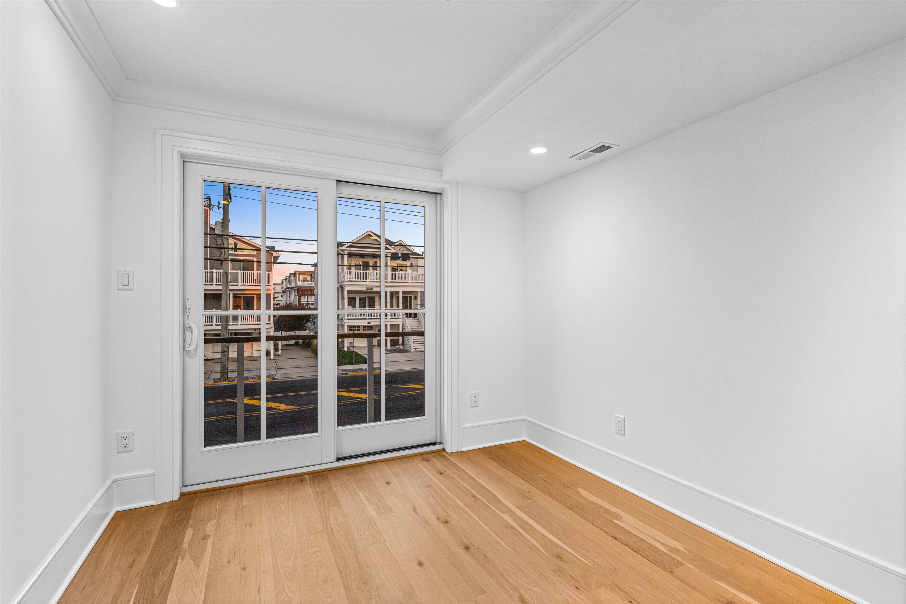 2148 Ocean, Unit 2148 Avalon, NJ 08202 - Photo 8 of 40 a view of empty room with wooden floor and windows