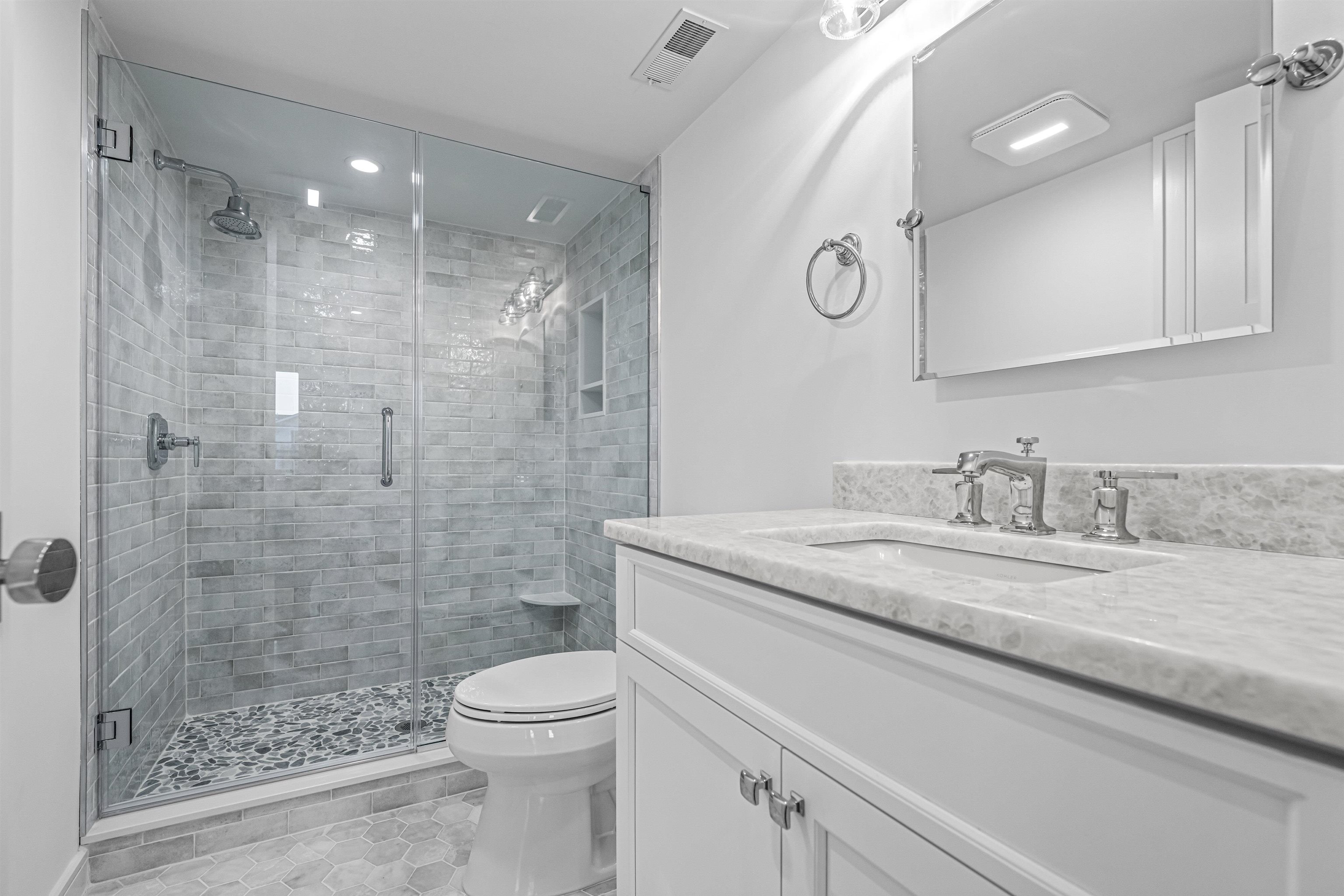 2148 Ocean, Unit 2148 Avalon, NJ 08202 - Photo 10 of 40 a bathroom with a granite countertop sink a toilet and shower